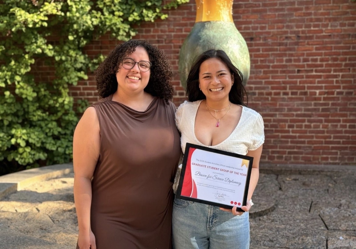 Brown for Science Diplomacy cofounders hold the "Graduate Student Group of the Year" from the Student Activities Office.