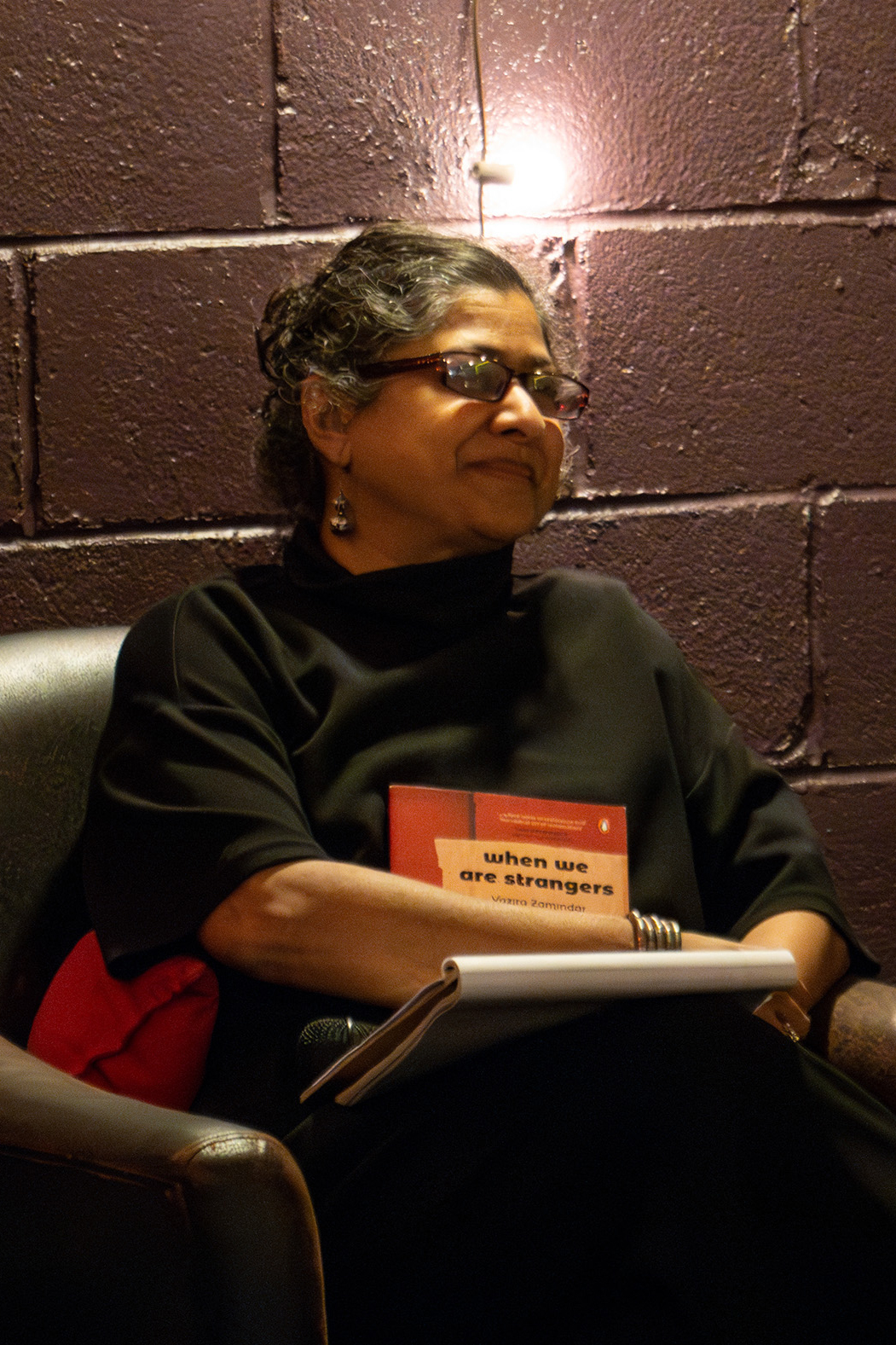 Zamindar smiles as she holds her book.
