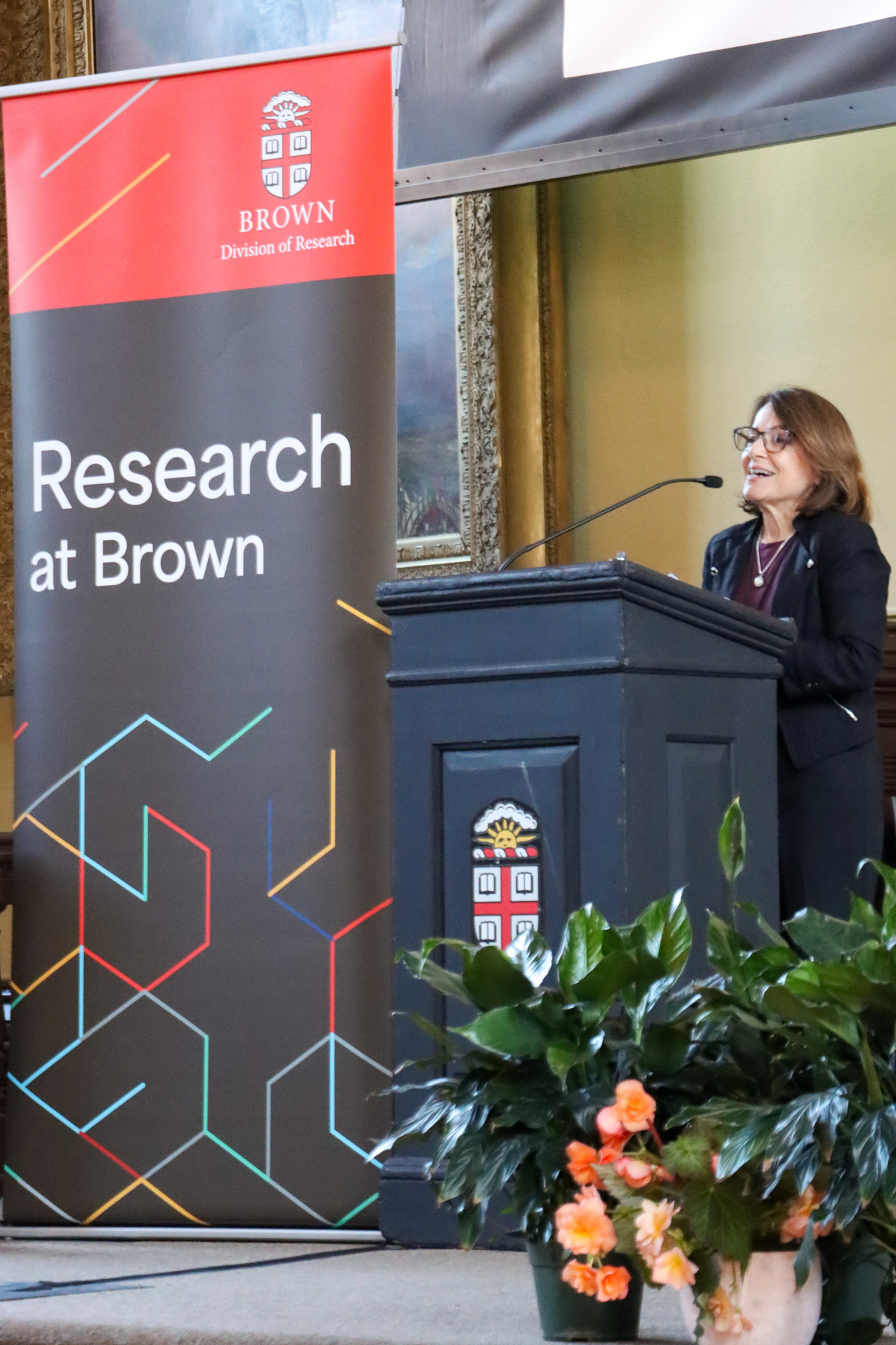 Wendy Schiller speaks on stage at a podium at the 2026 Celebration of Research.