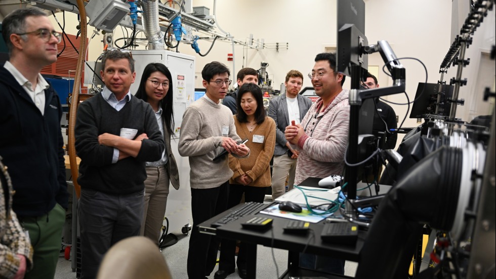 a group of people stand in lab